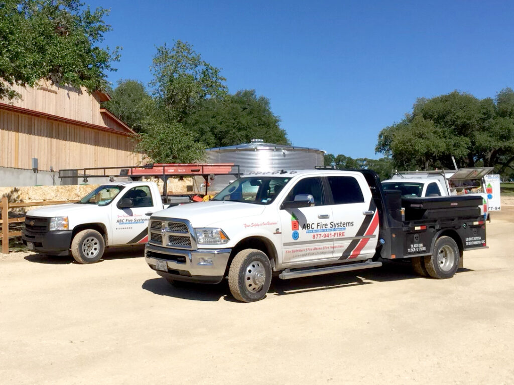 ABC Fire Systems service trucks parked on location